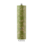 The Addison Ross Chinoiserie Salt and Pepper Mill Collection features a tall green cylindrical mill with floral and bird motifs, silver knob top, and "Green" label, showcasing elegant Chinoiserie style.