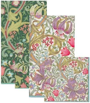 Four overlapping rectangular Caspari Golden Lily Collection biodegradable napkins, featuring intricate green, pink, purple, and cream floral and leaf patterns, are arranged against a white background.