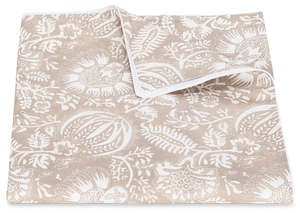 A beige cotton percale fabric featuring a white floral and leaf pattern, displayed on a plain background from the Matouk Granada Bedding Collection in Dune.