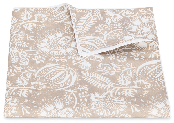 A beige cotton percale fabric featuring a white floral and leaf pattern, displayed on a plain background from the Matouk Granada Bedding Collection in Dune.