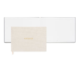 The Sugar Paper Flax Guest Book features premium linen book cloth with "GUESTS" embossed in gold, shown closed and open to blank pages—ideal for capturing memories.