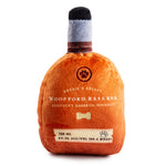 The Woofford Reserve Bourbon Dog Toy by Haute Diggity Dog is a plush, squeaky dog toy shaped like a whiskey bottle with fun dog-themed details—perfect for pups who love a bourbon-inspired twist.