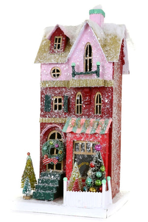 The Cody Foster "Gift Shop" is a decorative cardboard model house with red and pink walls, green steps, snowy accents, trees, wreaths, ornaments, a "Christmas" window sign, and festive packaging with clear dimensions.
