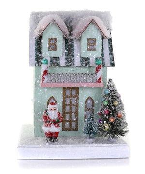 The Cody Foster Petite Mint House features a snow-covered design with a Santa figurine, ornamented Christmas tree, and candy cane columns—ideal for gifting and simple to protect with packaging materials or a sturdy box.