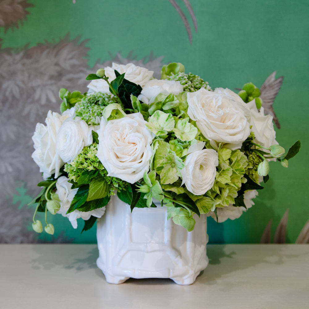 The Live Designer's Choice Floral Arrangement by Hive Floral Studio features elegant white roses, green hydrangeas, and greenery in a white ceramic vase—perfect for flower delivery.