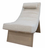 A modern, angular Sway Lounge Chair by McGuire Furniture with a wooden base and cushioned seat upholstered in neutral boucle fabric, featuring a rectangular headrest.