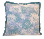The Bimini Sea Glass Outdoor Pillow by Hive Custom Pillows features a blue and white floral pattern with blue fringe, shown on a white background. This 22x22 square pillow adds stylish comfort to your patio or garden furniture.