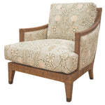 Inspired by 1940s French design, the St. Germain Lounge Chair by McGuire Furniture features a wooden frame and legs with light green and cream floral upholstery for a luxurious touch.