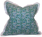 The Marbella Linen Emerald Pillow by Hive Custom Pillows features a green and blue floral pattern on a light blue background, white fringe edges, and is handmade in the USA.