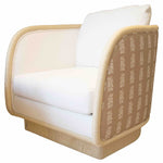 The McGuire Furniture Coastal Swivel Chair features white loose down and feather cushions, a beige wooden frame, and patterned side panels with a repeating white design on a tan background.