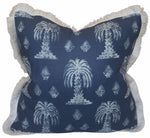 The Mandalay Indigo Pillow by Hive Custom Pillows is a square down-filled pillow with a navy cover featuring white palm tree and geometric patterns, light fringe trim, and is handmade in the USA for a stylish, cozy accent.