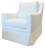 The Hannah Club Swivel Chair by Verellen is a modern classic with white upholstery, thick cushions, flared arms, and a skirted base—all crafted from sustainably harvested hardwood.