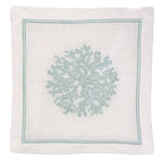 White linen napkin features a light blue embroidered coral design and matching stitched border. Pair it with Haute Home’s Sea Sponge Coaster Set for an elegant table setting.
