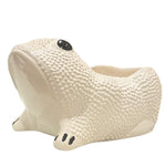 A white ceramic planter from the Jean Roger Paris Ceramic Frog Collection features textured skin and black painted eyes and toes, inspired by Jean Roger’s iconic frog designs.