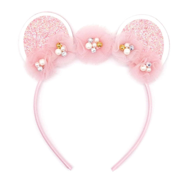 A Pink Poppy Claris Ears Headband adorned with pearls.