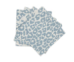 Four blue and white napkins from Matouk's Iconic Leopard Sky Tabletop Collection are stacked on a white background, bringing a bold accent to your classic table linens.