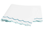 The Matouk India Bedding Collection, Cerulean, features folded white cotton percale sheets with scalloped edges trimmed in teal and turquoise and delicate embroidery.