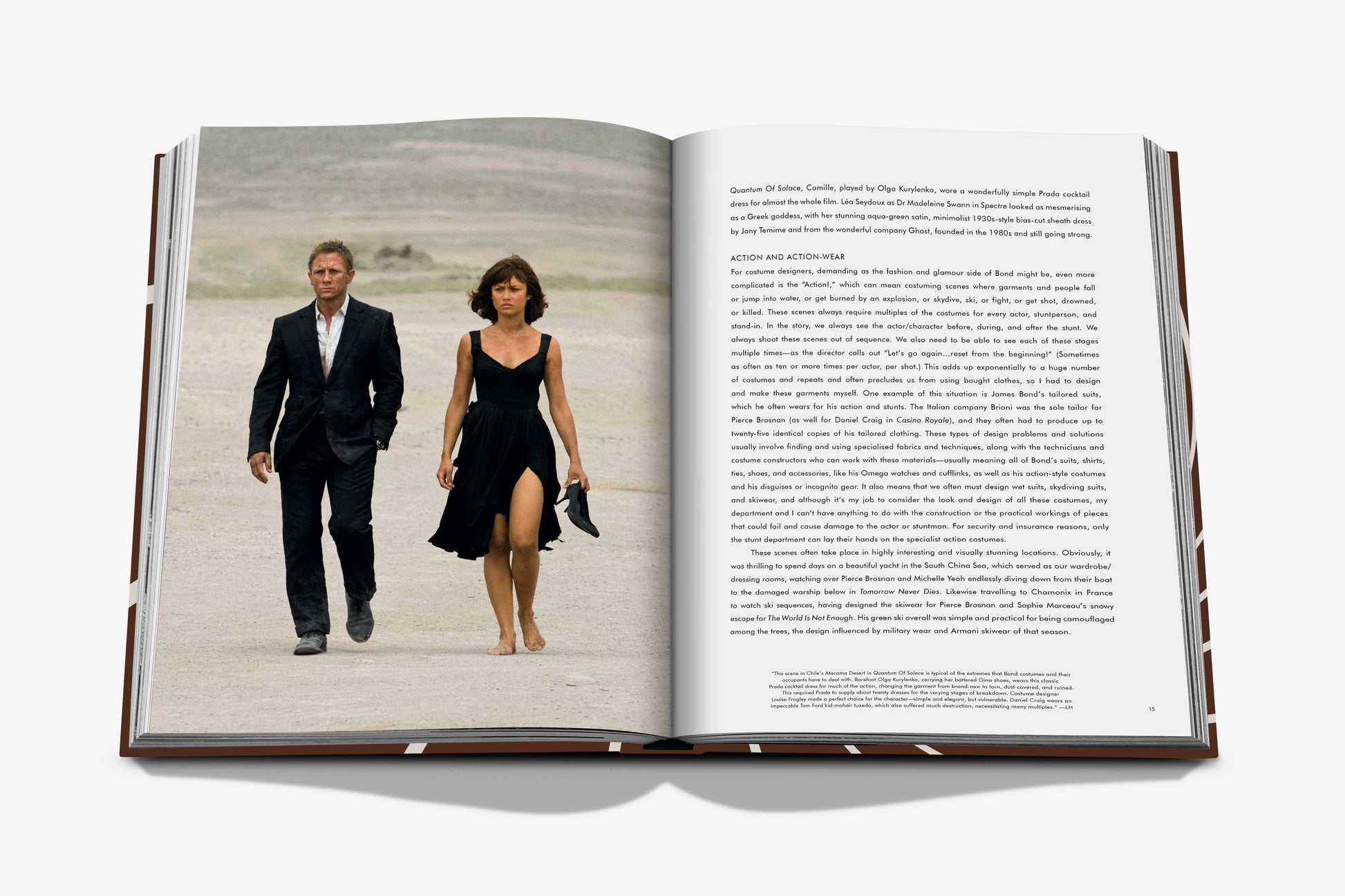Two individuals dressed in James Bond Style, a timeless fashion by Assouline, stroll across a sandy landscape depicted on the pages of an open book, with text gracing the left-hand page.