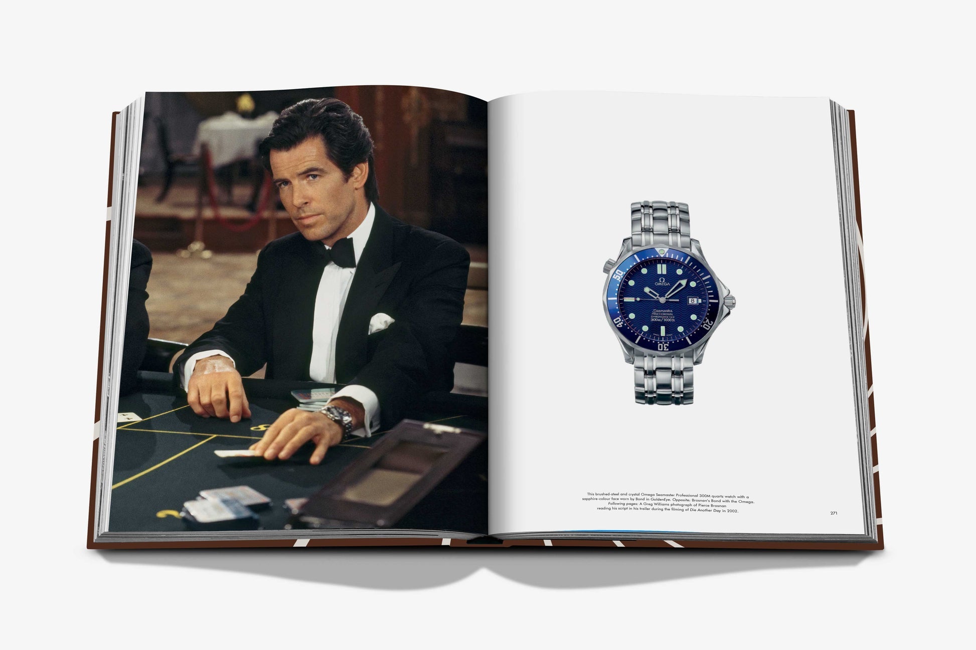 A book by Assouline titled "James Bond Style" showcases a man in a tuxedo at a card table on the left page, capturing the essence of James Bond, while a blue-faced wristwatch adorns the right page, representing timeless fashion.