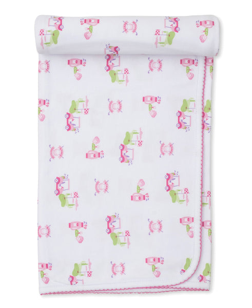 A Kissy Kissy Pink Golf Club Blanket with pink and green giraffes on it.