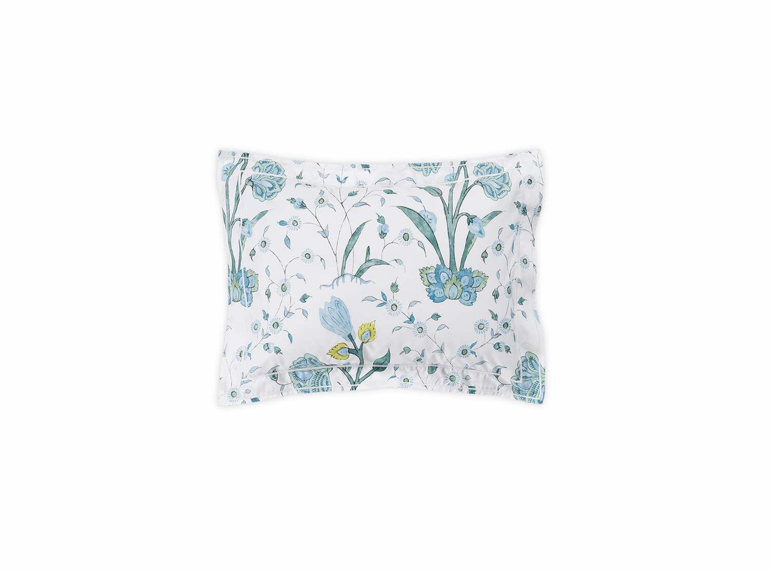 A rectangular pillow from the Matouk Schumacher Khilana Bedding Collection in blue, featuring a white background with a blue and green floral pattern inspired by Khilana hand-block textiles.