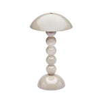 The Addison Ross Bobbin LED Cordless Lamp features a modern beige bobbin shape with a dome shade and four stacked glossy spheres. It offers adjustable light levels for versatile, portable lighting.
