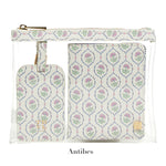 A transparent pouch holds the LUXE Saffiano Travel Set by TRVL Design—a matching floral-patterned luggage tag and passport cover, labeled "Antibes" below.