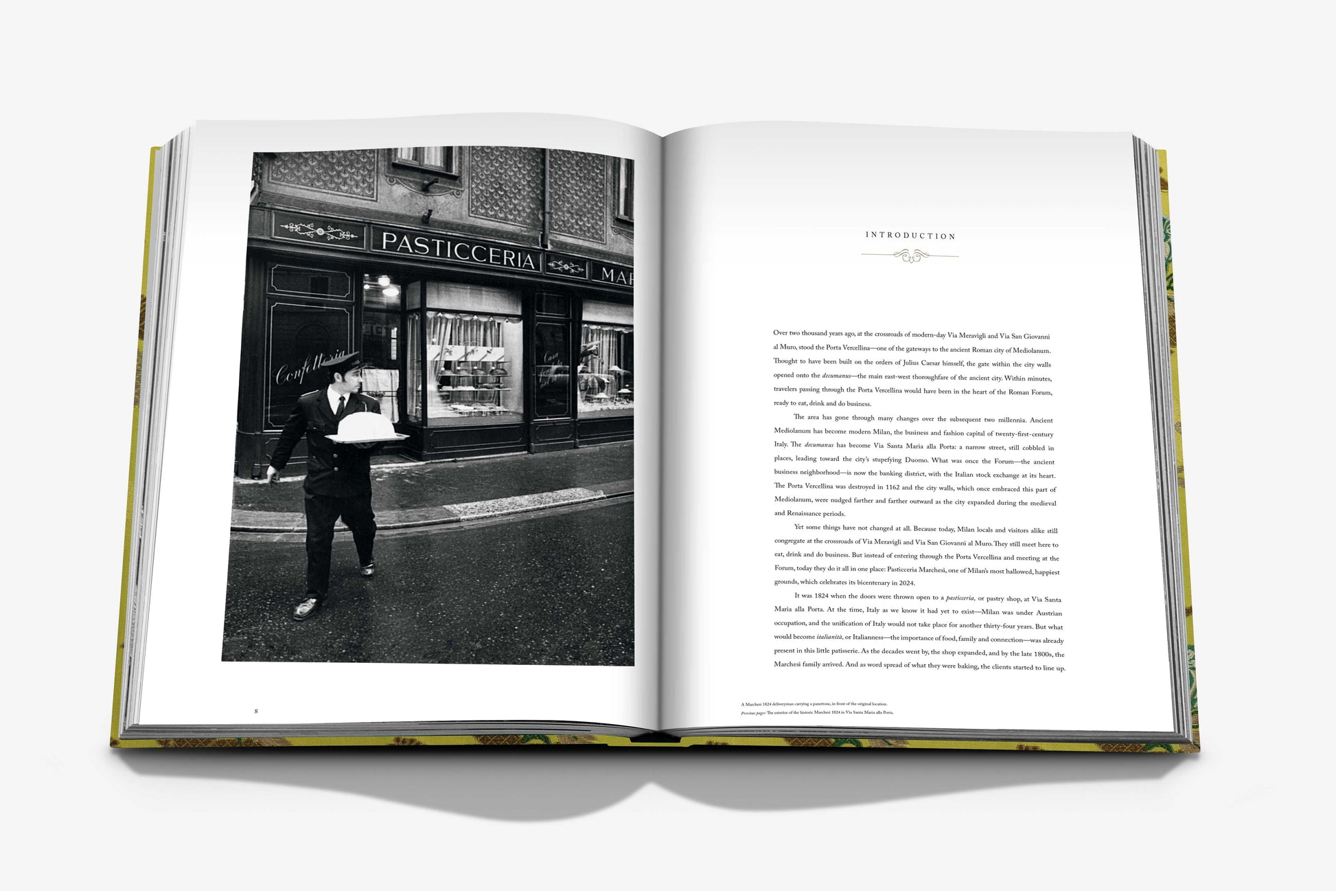 A photo in the open Assouline book shows someone with a cake outside Marchesi 1824, with a page titled "Introduction," suggesting the joys of holiday panettone and Italian cookies.