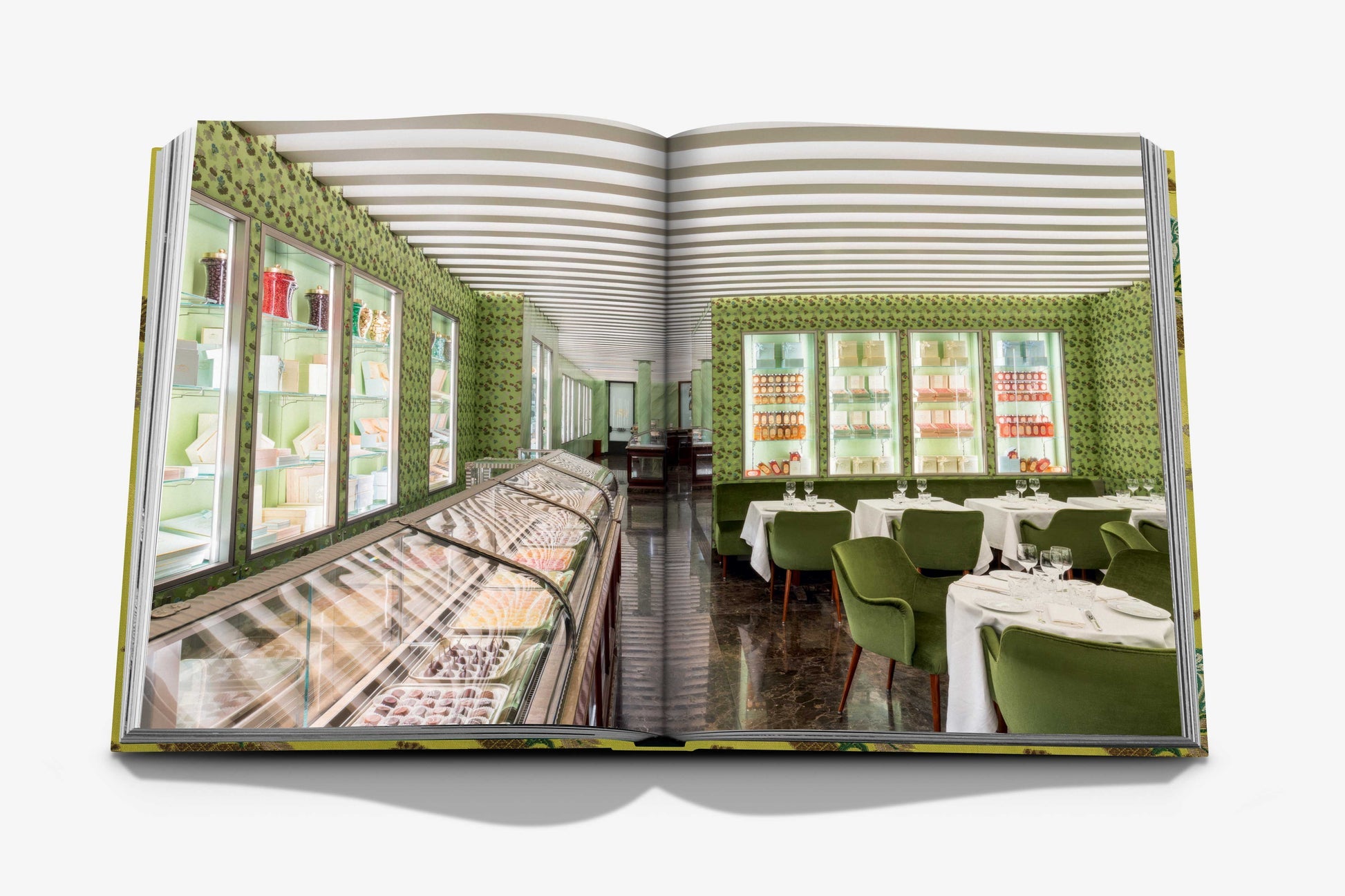 An open book displays a chic pastry shop interior with green chairs, a striped ceiling, and shelves filled with items. Marchesi 1824 by Assouline highlights the scene with its famous holiday panettone and classic Italian cookies, adding exquisite charm.