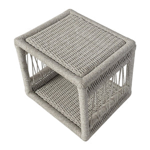 The Mara Outdoor Chaise Side Table by PALECEK features open sides with a solid woven synthetic rope top and bottom in neutral gray—ideal as a versatile outdoor accent or storage piece.