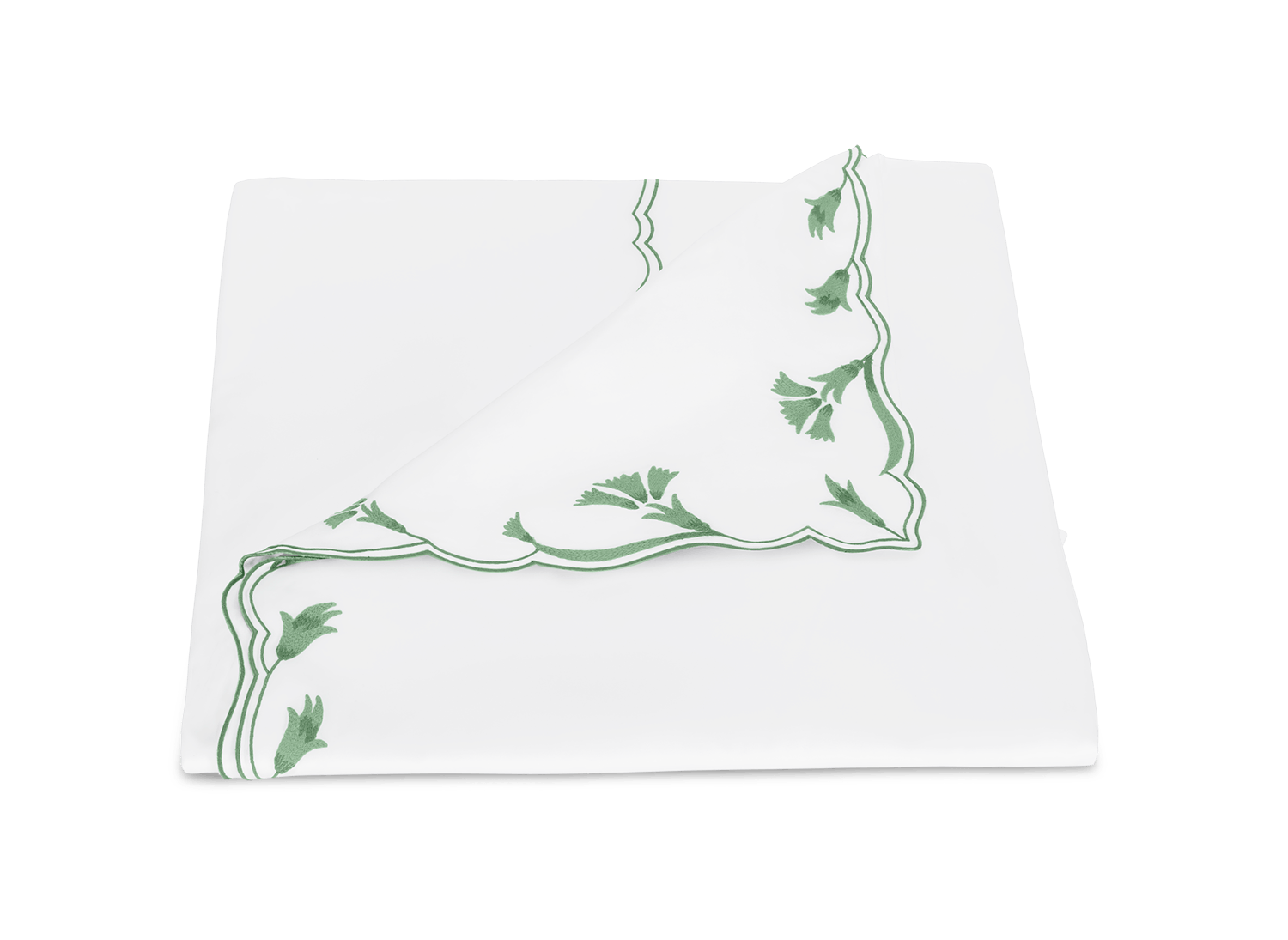 A neatly folded napkin from the Matouk Marcella Bedding Collection in Clover, featuring green scalloped florals and delicate embroidery, is displayed on a plain white background.