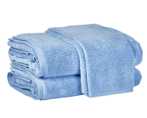 Two neatly folded Azure cotton towels from Matouk’s Milagro Bath Collection are stacked together against a white background, highlighting the brand’s signature absorbency and quality.