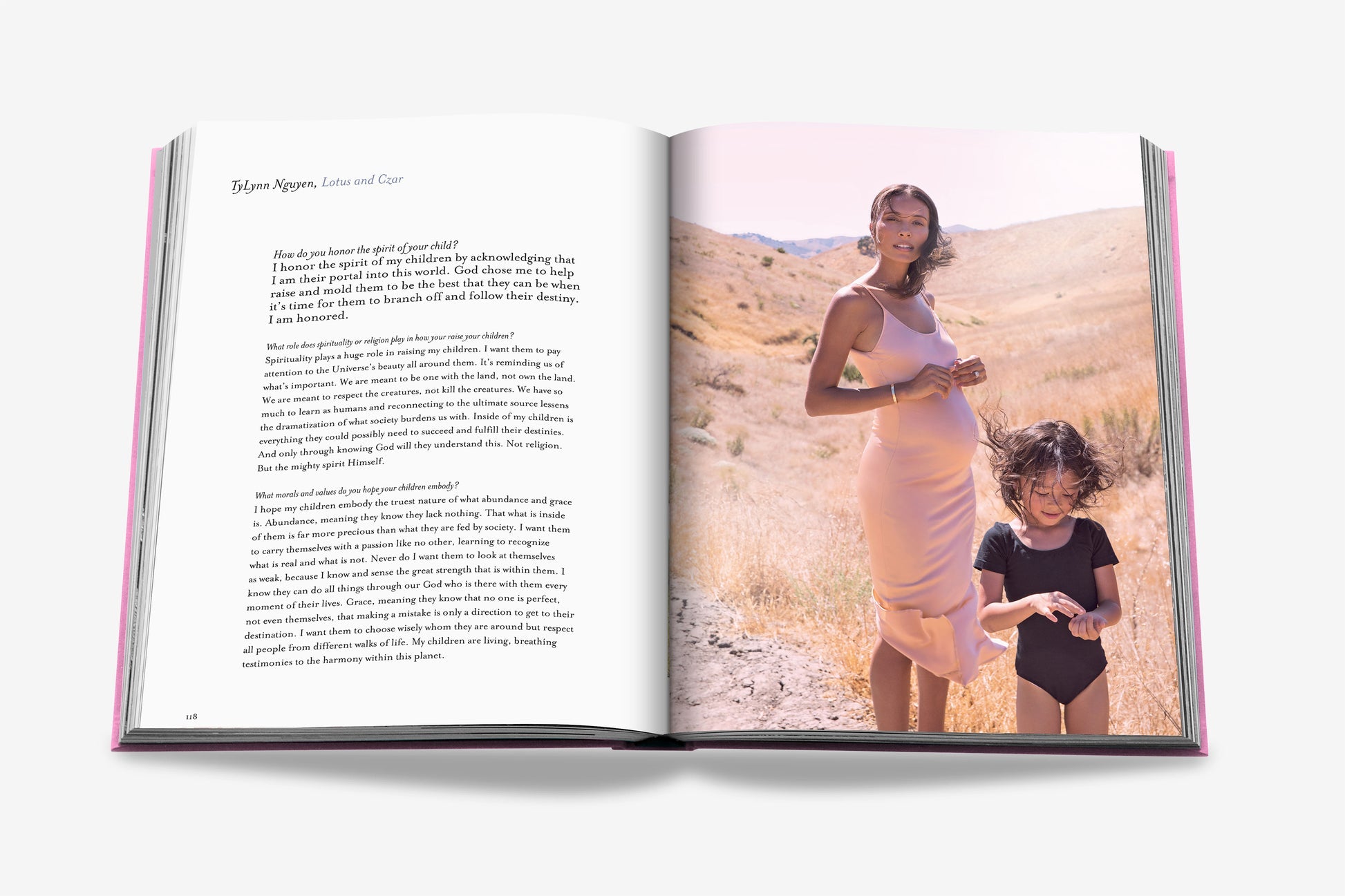 Open book from Assouline, "Mother and Child": a pregnant woman in a light pink dress stands in a dry grassy field with a child in black. Text by Claiborne Swanson Frank is featured on the left page.