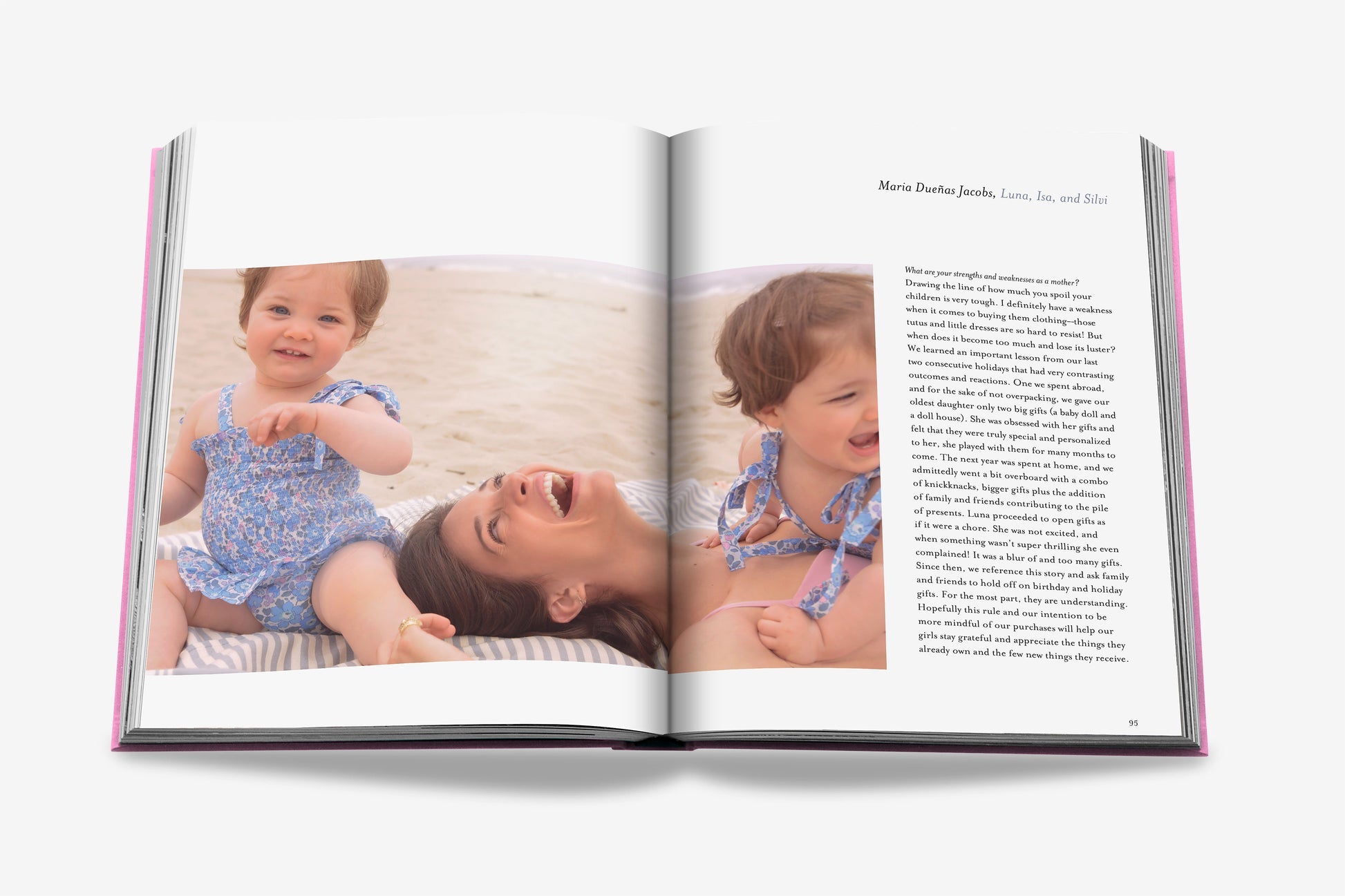 An open copy of "Mother and Child" by Assouline reveals an evocative portrait by Claiborne Swanson Frank of a woman with two children on a beach, alongside text—a striking glimpse into modern motherhood.