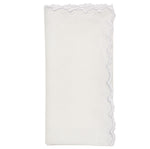 The Arches Napkin Set by Kim Seybert features folded white linen napkins with a geometric design and a scalloped, embroidered edge on one side, shown against a plain white background.