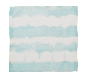 The Kim Seybert Watercolor Stripe Napkin Set features a soft linen cloth with blue and white tie-dye stripes, reminiscent of watercolor patterns.
