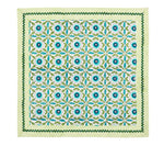 The Majorelle Napkin Set by Kim Seybert features a floral and geometric pattern in blue, green, and yellow, accented with diagonal yellow stripes and a green zigzag border, inspired by handcrafted napkins and Indian block printing.