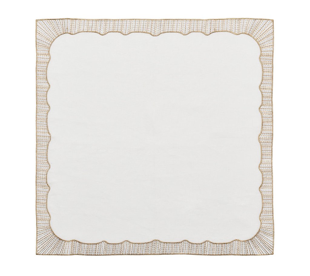The Kim Seybert Frame Napkin Set features square white linen napkins with scalloped edges and a patterned gold embroidered border, offering elegant metallic accents for a refined touch.
