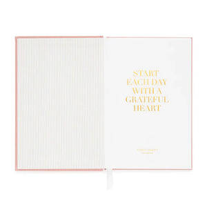 The Sugar Paper Gratitude Sage Journal features a striped left page and a right page with "START EACH DAY WITH A GRATEFUL HEART" in gold—perfect for your daily check-in and appreciation practice.
