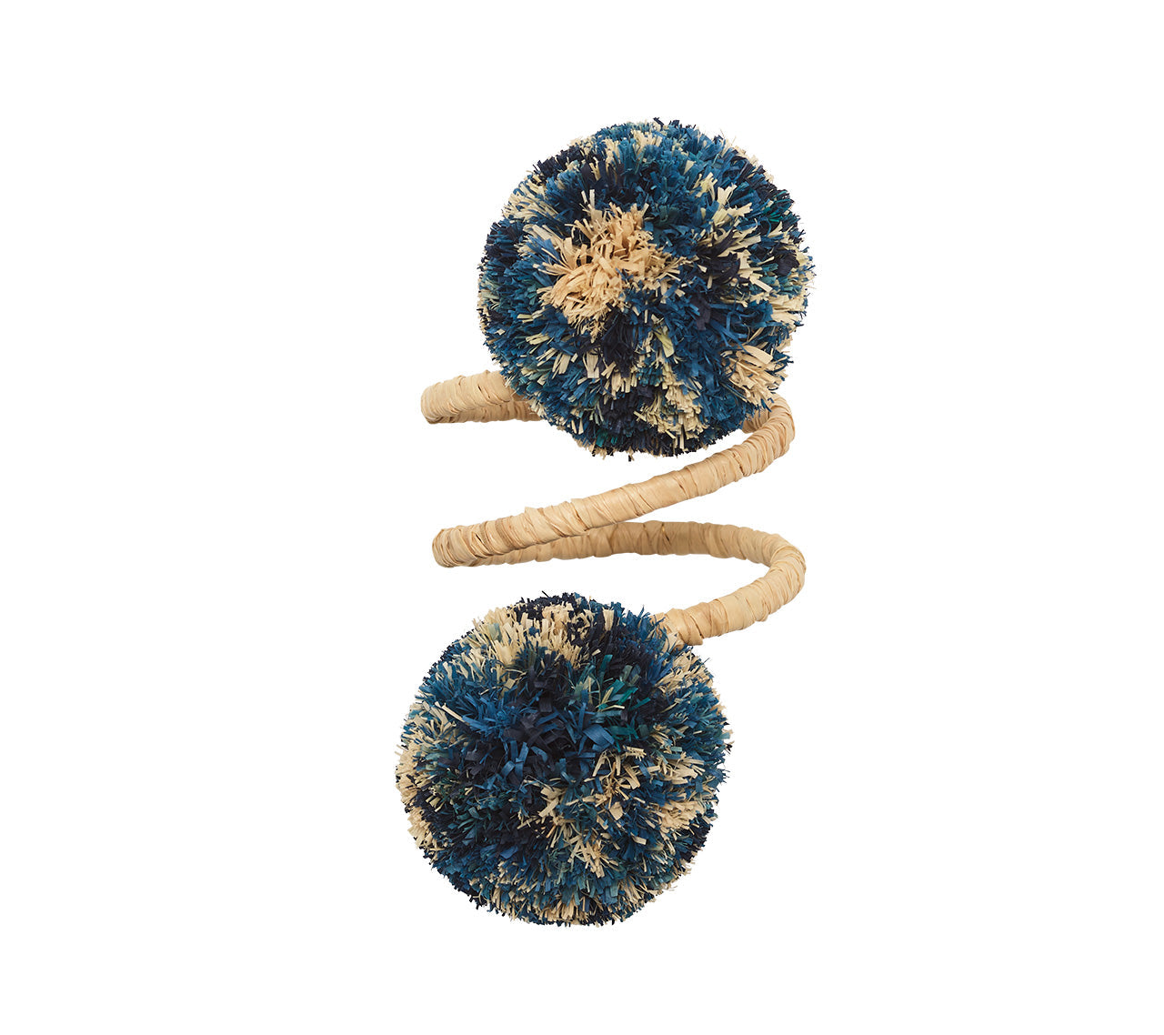 The Casbah Napkin Ring by Kim Seybert features a spiral shape wrapped in natural raffia with two large blue and beige textured pom-poms, showcasing organic elegance against a white background.