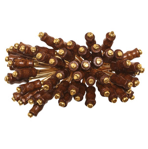 The Kim Seybert Royal Palm Napkin Ring features gold-tipped brown wooden sticks arranged radially, bringing subtle tropical flair to your table setting.