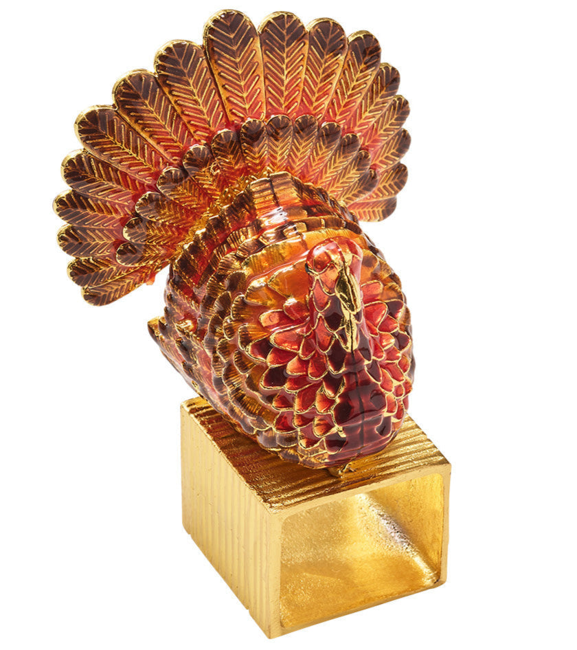 The Kim Seybert Turkey Trot Napkin Ring Set features decorative gold and red turkey figurines on metallic gold square bases, perfect for autumn table décor or adding a festive touch to your Thanksgiving celebration.