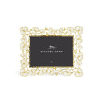 The Michael Aram Orchid Frame showcases a gold and white floral design with a "Michael Aram" and "5x7" placeholder, reflecting the Orchid Collection's elegance and understated luxury.