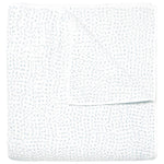 The Stitched Mist Coverlet by John Robshaw is a folded white organic cotton voile blanket with a subtle grid texture and faint blue stitching, displayed on a plain white background.