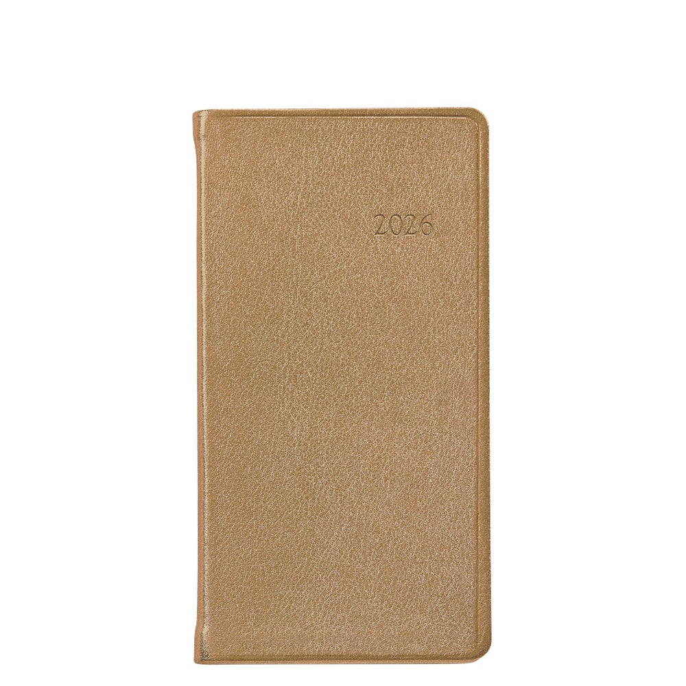 A tan, textured 2026 Pocket Journal Planner from Graphic Image, featuring rounded corners and Smyth sewn binding, is shown closed on a white background.
