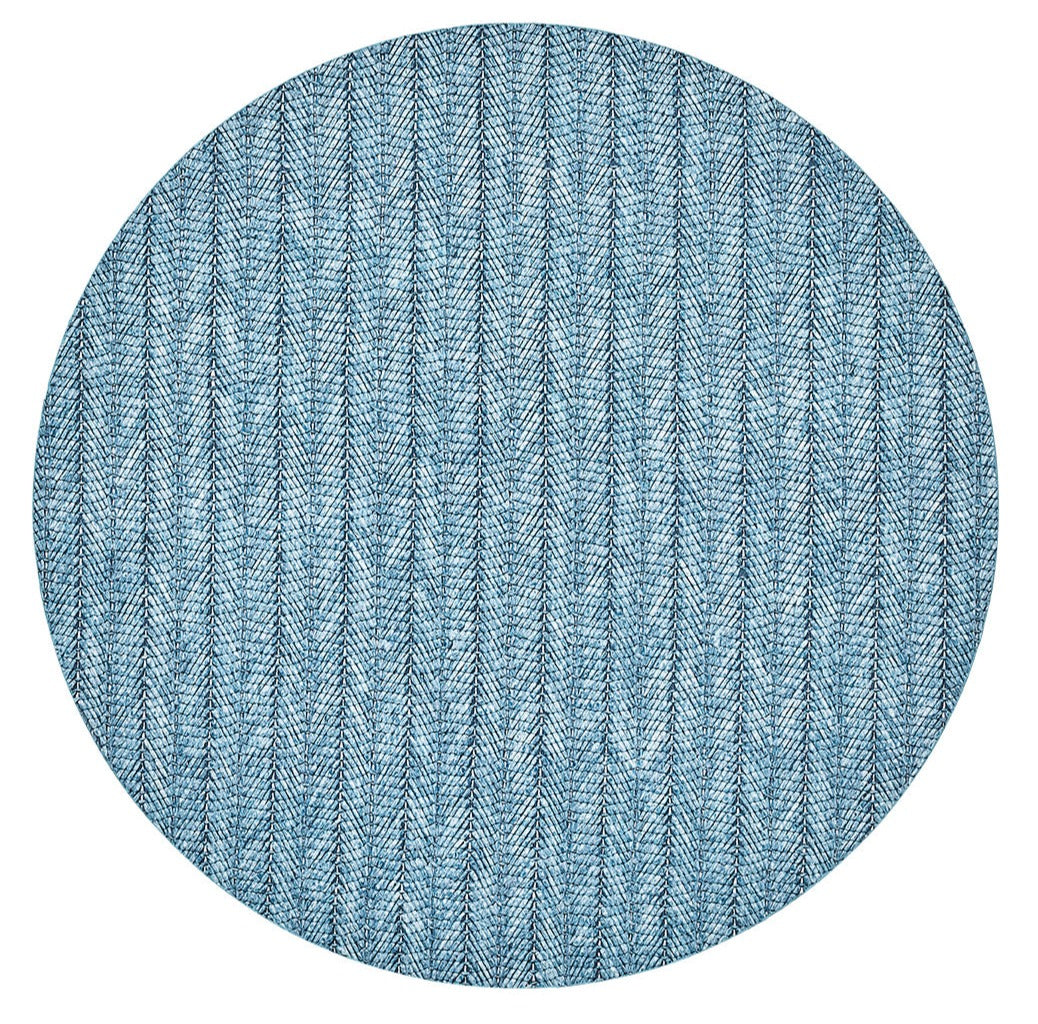 The Kim Seybert Herringbone Placemat, featuring a blue herringbone pattern and crafted from durable polyvinyl, is displayed against a white background—perfect for refreshing your spring and summer dining table.
