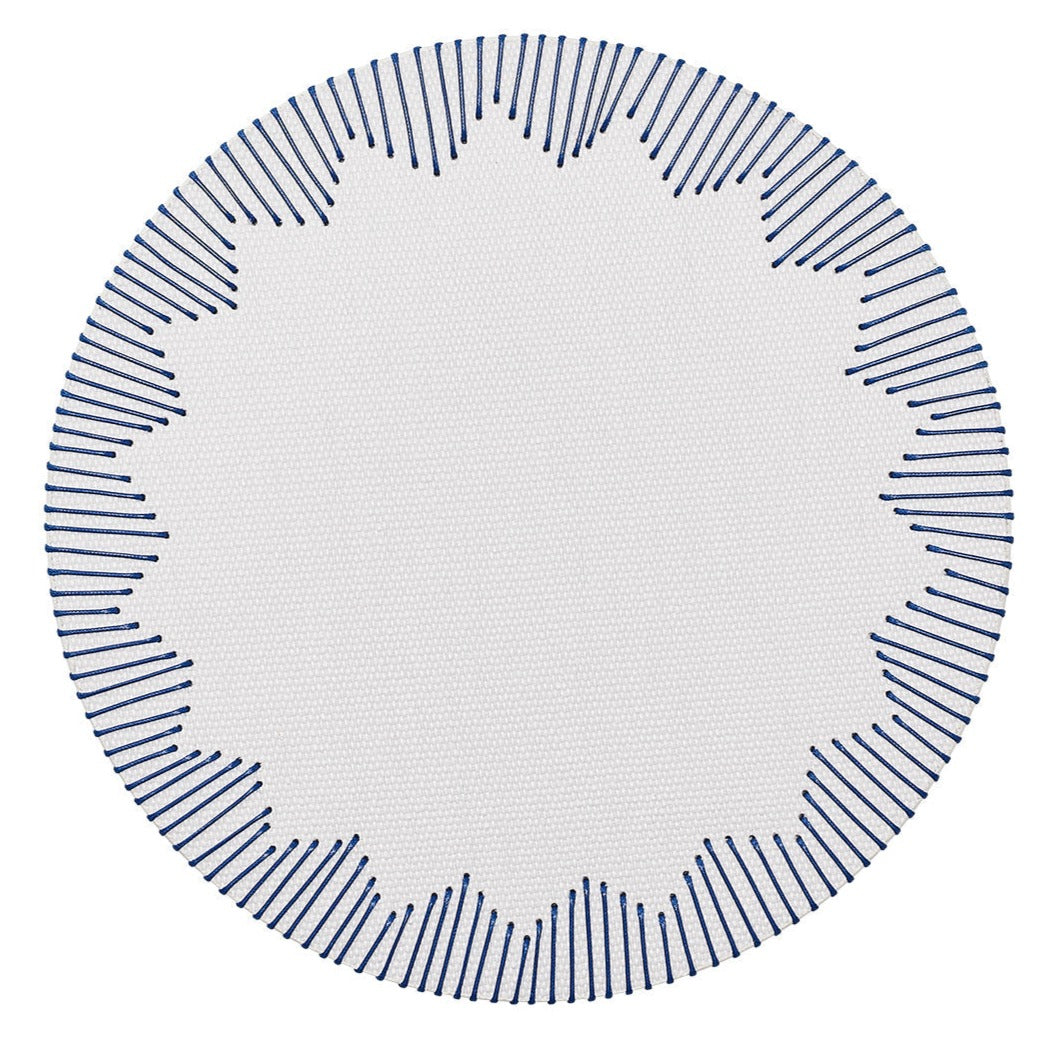 The Kim Seybert Dream Weaver Placemat features a circular white design with a stitched dark blue border and starburst blue radial lines—ideal for adding woven style to summer entertaining.
