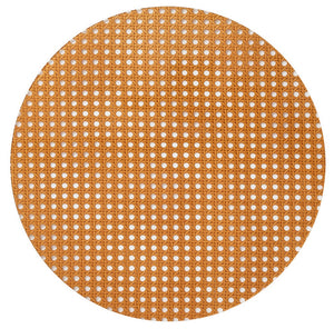 The Kim Seybert Reed Placemat features woven cane webbing with a hexagonal lattice pattern, offering a faux-wicker look that's ideal for outdoor entertaining on a white background.