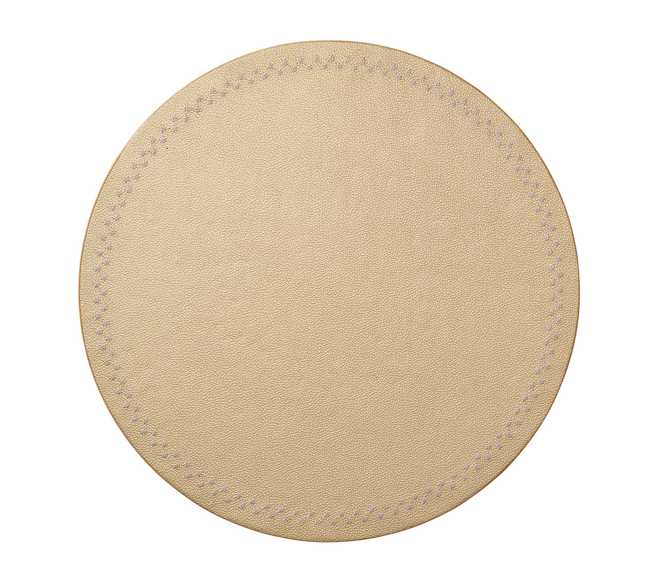 The Starry Night Placemat Collection by Kim Seybert features a round, beige leather coaster with metallic trim and visible stitched edges. Photographed on a white background, it offers effortless cleaning while adding style to your table.