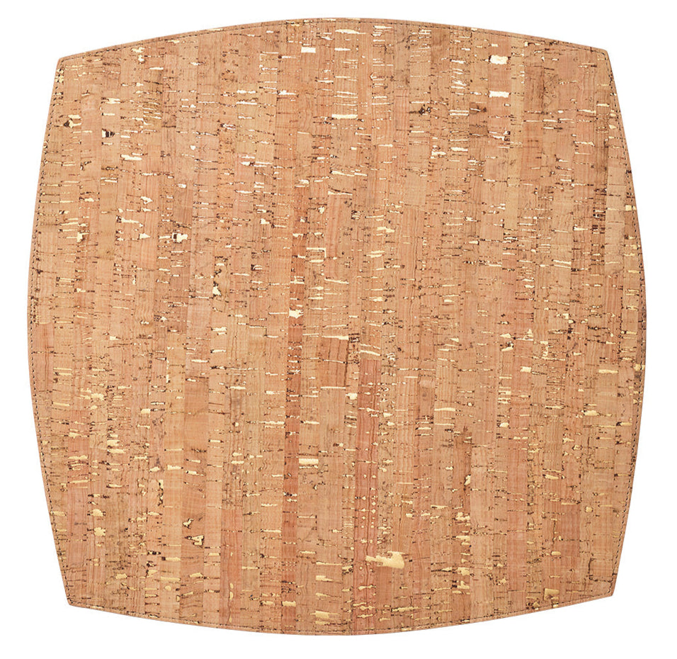 The Kim Seybert Whistler Placemat features a square cork design with rounded edges, a natural speckled pattern, and a light brown hue—ideal for rustic decor and highlighting sustainable craftsmanship.